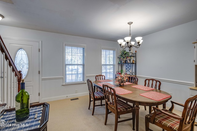 74 Driftwood Ct, Arapahoe, NC 28510 - dining space featuring a chandelier, light colored carpet, and stairs