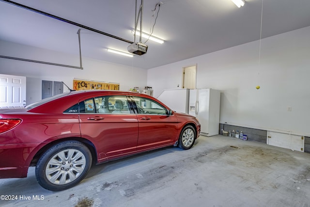 garage with a garage door opener and electric panel