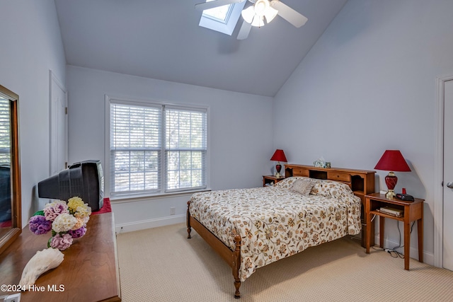 bedroom featuring ceiling fan, high vaulted ceiling, carpet flooring, and a skylight