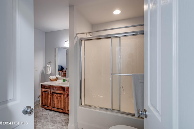 full bathroom featuring vanity, toilet, and enclosed tub / shower combo