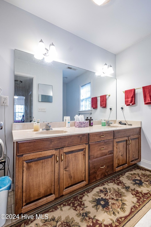 bathroom featuring vanity and a shower with shower door