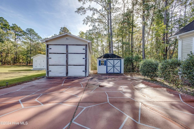 74 Driftwood Ct, Arapahoe, NC 28510 - detached garage featuring a storage unit and concrete driveway