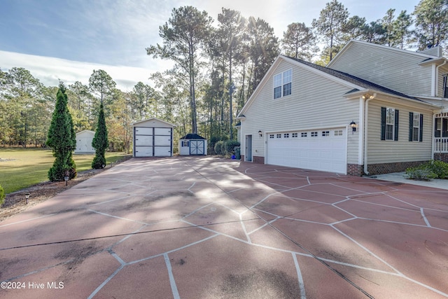 74 Driftwood Ct, Arapahoe, NC 28510 - view of side of property featuring a storage unit, driveway, an outbuilding, and a garage