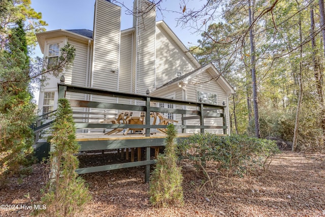 74 Driftwood Ct, Arapahoe, NC 28510 - back of property featuring a chimney and a deck