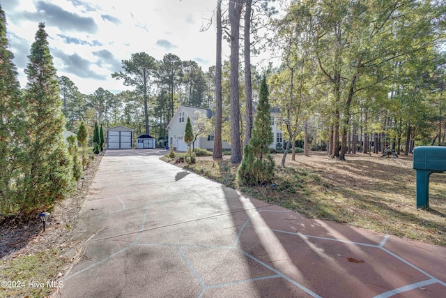 74 Driftwood Ct, Arapahoe, NC 28510 - view of community with a detached garage, concrete driveway, and an outdoor structure