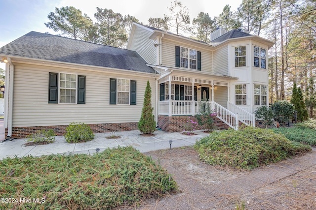 74 Driftwood Ct, Arapahoe, NC 28510 - victorian-style house with a porch, a chimney, a shingled roof, and stairs