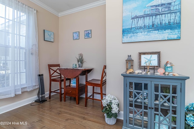 dining area featuring hardwood / wood-style floors and crown molding