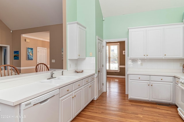 kitchen with decorative backsplash, white cabinets, dishwasher, range, and lofted ceiling