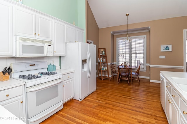 kitchen with white cabinetry, white appliances, and hanging light fixtures