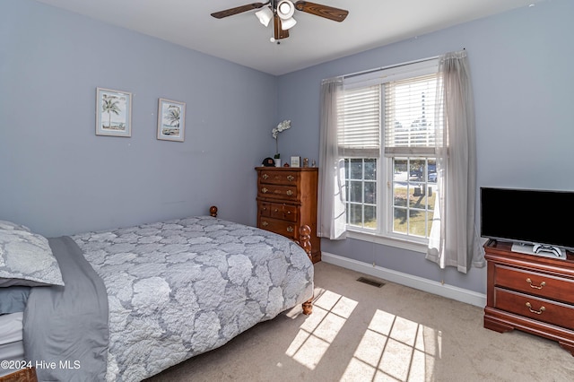 bedroom featuring ceiling fan and light carpet