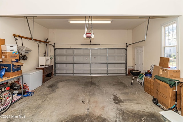 garage with refrigerator and a garage door opener