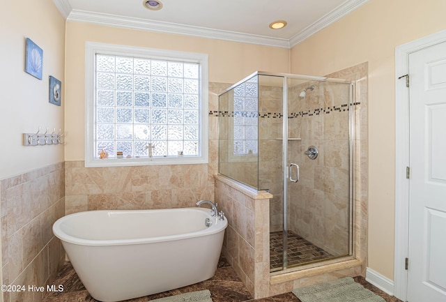 bathroom featuring shower with separate bathtub, tile walls, and crown molding