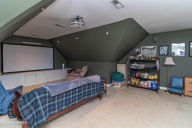 carpeted bedroom with lofted ceiling