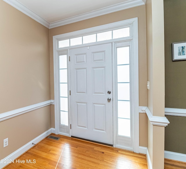 foyer featuring light hardwood / wood-style floors and ornamental molding