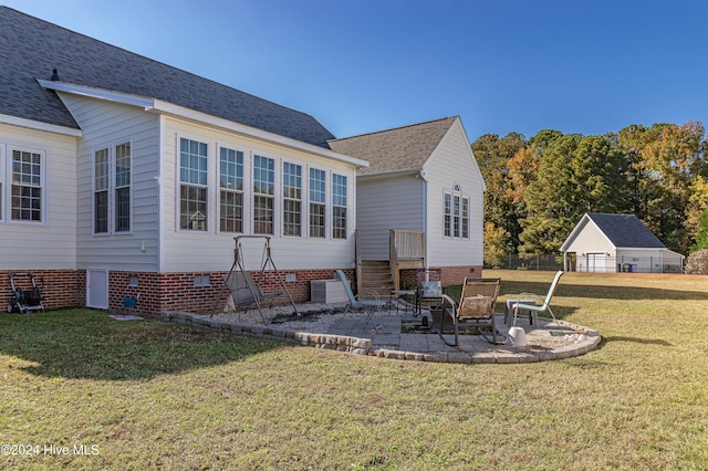 rear view of property with a lawn and a patio area