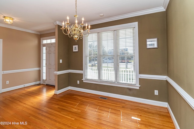 interior space featuring crown molding, plenty of natural light, and hardwood / wood-style floors