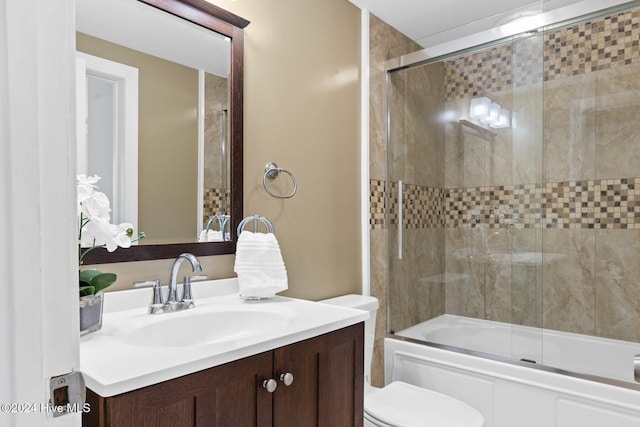 full bathroom featuring vanity, toilet, and enclosed tub / shower combo