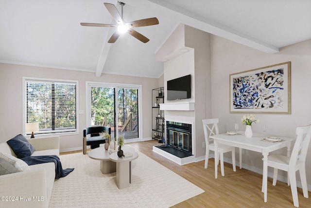 living room featuring vaulted ceiling with beams, light hardwood / wood-style flooring, and ceiling fan