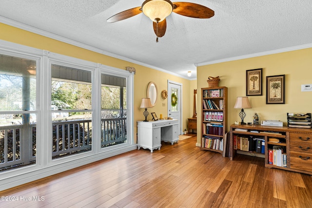 miscellaneous room with ceiling fan, a textured ceiling, light hardwood / wood-style flooring, and crown molding