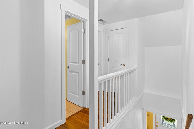 hallway with light hardwood / wood-style floors