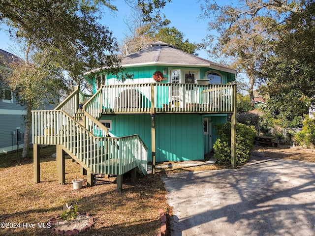 rear view of house with a wooden deck