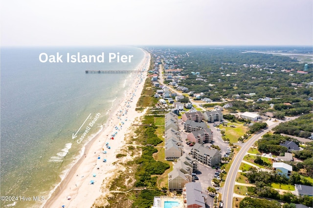 drone / aerial view with a water view and a view of the beach