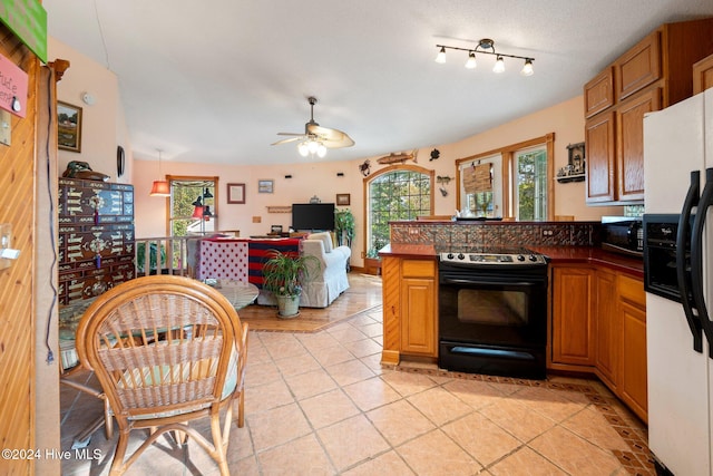 kitchen with ceiling fan, kitchen peninsula, a textured ceiling, light tile patterned floors, and black appliances