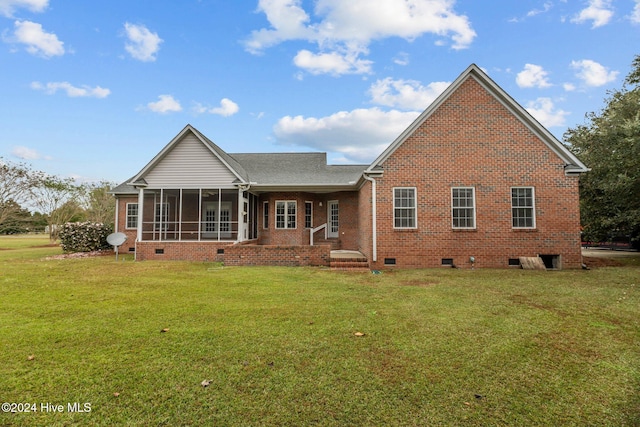 rear view of property featuring a sunroom and a yard