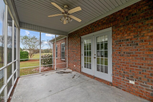 unfurnished sunroom with french doors and ceiling fan