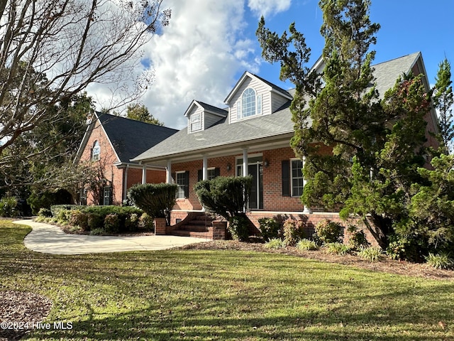 new england style home featuring a front yard