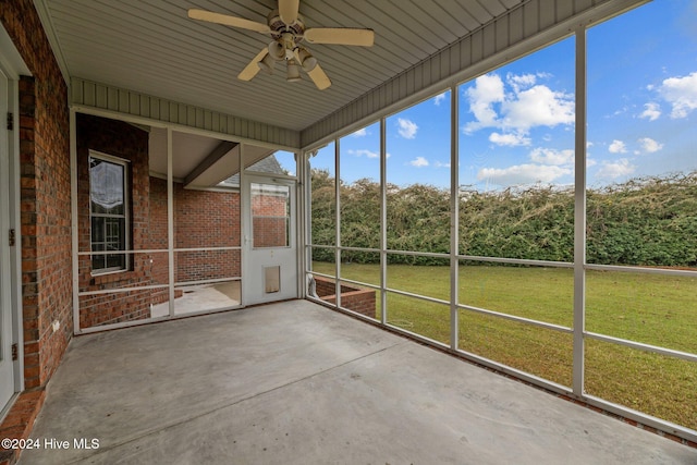 unfurnished sunroom with ceiling fan