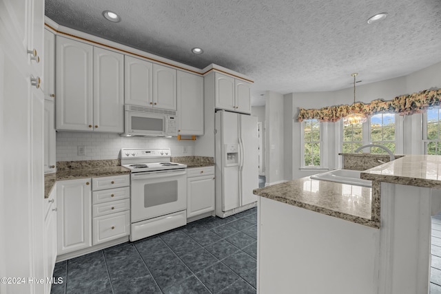 kitchen with white cabinets, decorative light fixtures, white appliances, and sink