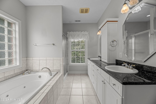 bathroom with vanity, tile patterned floors, and separate shower and tub