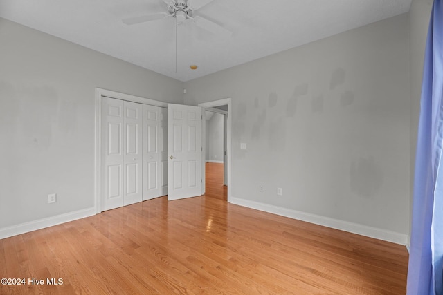 unfurnished bedroom featuring ceiling fan, a closet, and light hardwood / wood-style floors