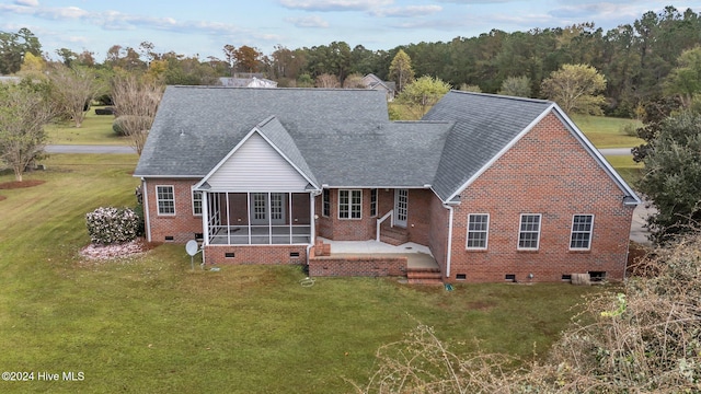 rear view of property featuring a lawn and a patio