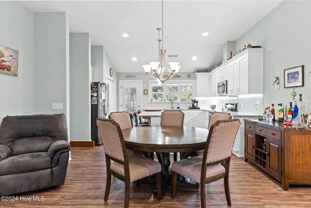 1296 Marsilio Ln SW Unit A, Ocean Isle Beach, NC 28469 - dining space with a chandelier, wood finished floors, lofted ceiling, and recessed lighting