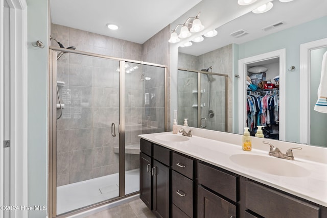 bathroom featuring an enclosed shower and vanity