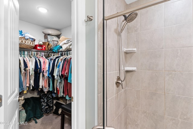 bathroom with a shower with door