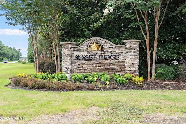 community / neighborhood sign with a lawn