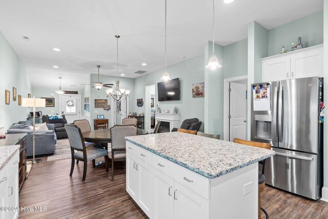 1296 Marsilio Ln SW Unit A, Ocean Isle Beach, NC 28469 - kitchen featuring stainless steel fridge, open floor plan, a center island, dark wood-type flooring, and decorative light fixtures