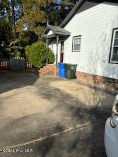 view of property exterior with a patio area