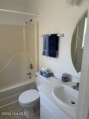 full bathroom featuring vanity, tile patterned floors, toilet, and bathtub / shower combination