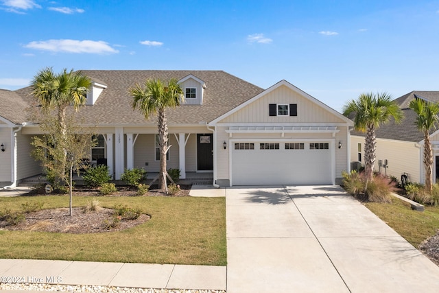 view of front of property with a porch, central AC, a front lawn, and a garage