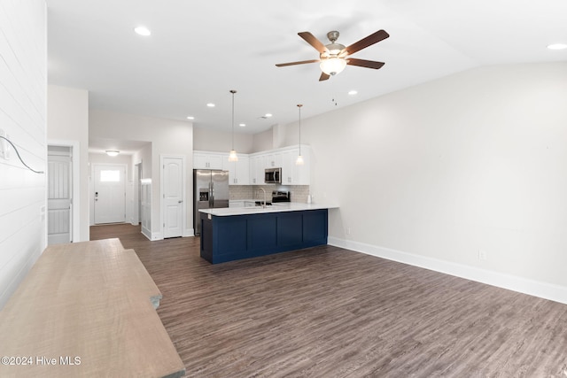 kitchen with stainless steel appliances, white cabinetry, kitchen peninsula, pendant lighting, and dark hardwood / wood-style flooring