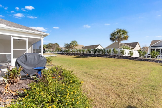 view of yard featuring a sunroom