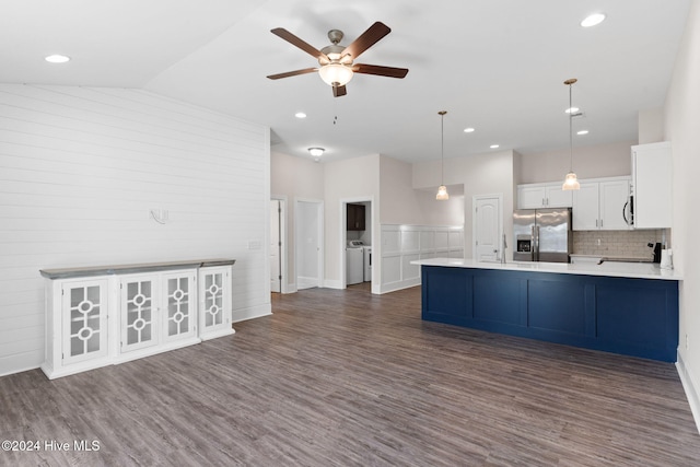 kitchen featuring stainless steel appliances, vaulted ceiling, dark hardwood / wood-style floors, white cabinetry, and decorative light fixtures