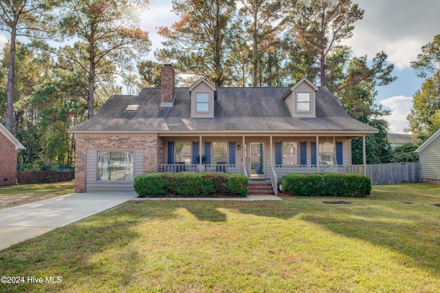 new england style home featuring covered porch and a front yard