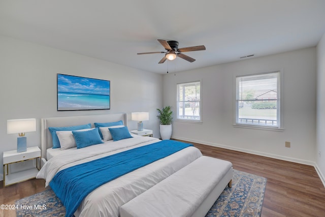 bedroom with ceiling fan and dark hardwood / wood-style floors