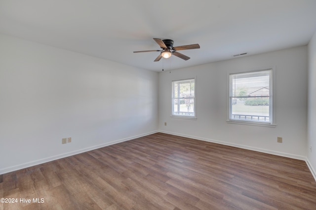 empty room featuring wood-type flooring and ceiling fan