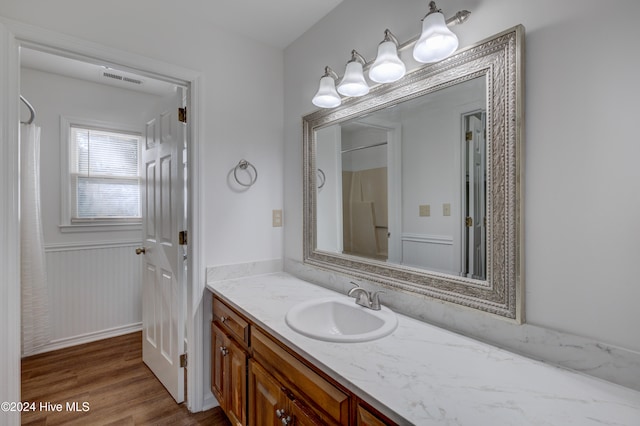 bathroom with vanity and hardwood / wood-style flooring